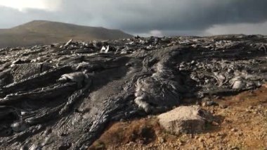 4K close-up footage of Cold Lava in Fagradalsfjall active volcano in Geldingadalir, Reykjanes, Iceland. River of Cold Lava Flowing down the hill.