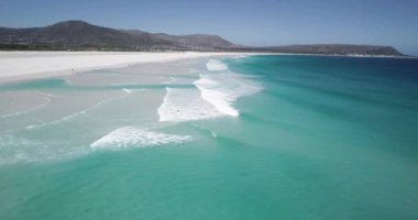 Noordhoek Long Beach 'in 4K hava aracı görüntüleri, Cape Town, Güney Afrika. Okyanus dalgalarının geniş görüşü. Turkuaz temiz su ve beyaz kumsal. Yüksek kalite 4k görüntü
