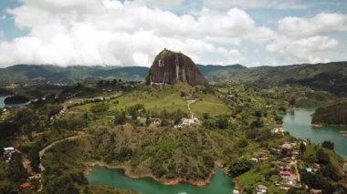 Kolombiya, Medellin yakınlarındaki El Penon de Guatape 'in insansız hava aracı görüntüleri. Büyük ve benzersiz bir kaya. Tepeye çıkan merdivenleri var. Turistik bir yer. Kolombiya 'da büyük bir taş. Yüksek kalite 4k görüntü.