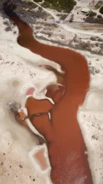 Salinas de Manaure veya Manaure tuz düzlükleri yakınlarındaki turuncu demir gölü gösteren hava aracı görüntüleri, Kuzey Kolombiya, Latin Amerika. Güzel kuzey Kolombiya doğası, turuncu göl ve çöl. 4K görüntü.