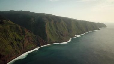 Portekiz 'in Madeira Adası' nda, gün batımında Santa Maria Madalena etrafındaki Ponta da Ladeira dağlarının üzerinden geçen insansız hava aracı görüntüleri. Kuzeybatı kısmı zirveler ve zirveler. Yüksek kalite 4k görüntü