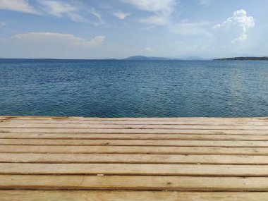 Sakin Ufuk: Sınırsız Gökyüzünün Sonsuz Deniz 'le buluştuğu, Sonsuz Olasılıkları sembolize ettiği Ahşap İskelenin Ötesinde Bir Yolculuk