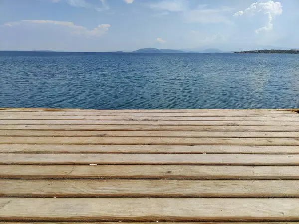 stock image Calm Horizon: A Journey Beyond the Wooden Pier, Where the Boundless Sky Meets the Infinite Sea, Symbolizing Endless Possibilities