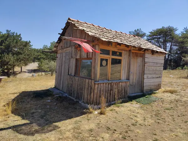 stock image Rural Resilience: A Rustic Cabin with the Turkish Flag, Symbolizing National Pride and Simplicity Amidst Nature's Embrace