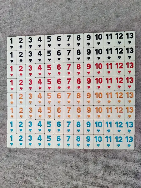 stock image Order in Chaos: A Neatly Arranged Set of Rummikub Tiles Displaying Different Numbers and Colors, Reflecting the Harmony and Balance Amidst Diversity, Like Life's Organized Complexity