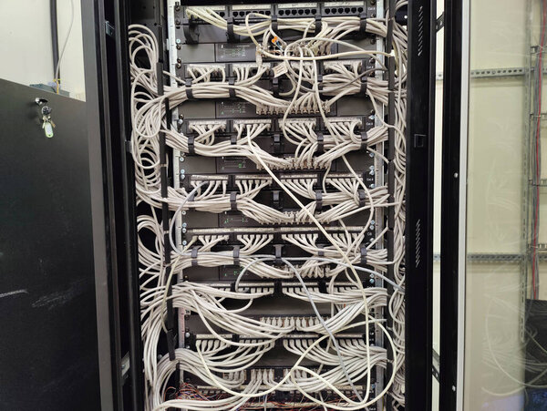 Complex Network Server with Dense Cable Management and Surveillance Screen, Reflecting Connectivity and Security Infrastructure