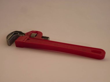 A Toy Pipe Wrench on a Soft Fleece Backdrop: Symbolizing the Power of Imagination in a Child's Play Tools. clipart