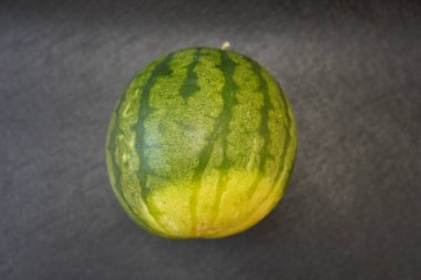 Rough Beauty of a Watermelon: A Close-Up of Natures Layers, Imperfection, and Growth Illuminated in Contrast clipart