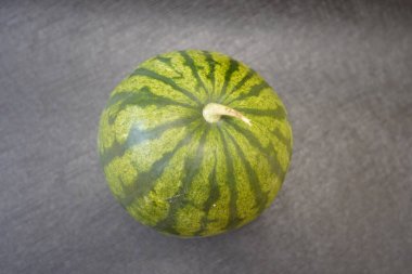 Rough Beauty of a Watermelon: A Close-Up of Natures Layers, Imperfection, and Growth Illuminated in Contrast clipart