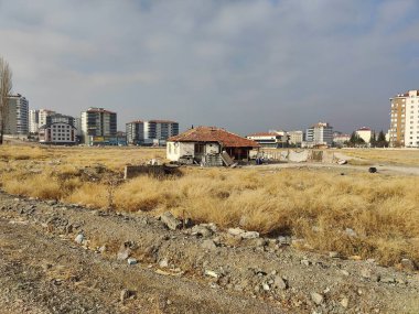 Turkiye, December 2, 2024, Urban Transformation: A Lonely Shack Amid Rising Modernity, Reflecting the Clash of Past and Future, Resilience, and the Displacement of Tradition in Expanding Cities. clipart