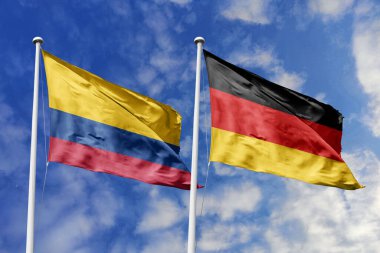 Kolombiya ve Almanya, güçlü uluslararası bağları, kültürel değişimi ve küresel işbirliğini simgeleyen mavi gökyüzüne karşı gururla el sallıyor..