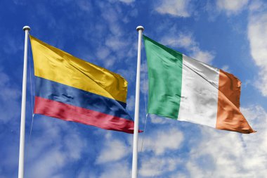 Kolombiya ve İrlanda bayrakları, uluslararası dostluğu, diplomatik bağlantıları ve küresel çeşitliliğin birliğini simgeleyen açık mavi gökyüzüne gururla sergileniyor..