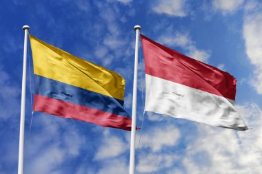 Kolombiya ve Monako bayrakları gururla el sallayarak uluslararası ilişkileri, dostluğu ve kültürel değişimi simgeliyor..