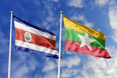 Kosta Rika ve Myanmar bayrakları, iki ülke arasındaki uluslararası ilişkiler, dostluk ve diplomasiyi simgeleyen canlı mavi gökyüzüne gururla el sallıyor.