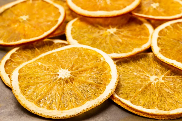 Heap of dry orange slices. Fruit snack. Close up. Top view.
