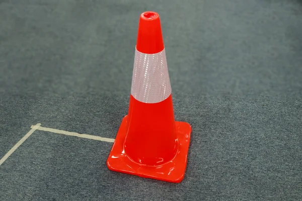 Photo of a red traffic cone, this tool serves to give a sign not to cross, or prohibit it
