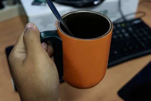 A worker Drinks hot coffee in the morning while working in the office