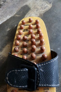 Bir Çin akupunktur ve refleksoloji aracı, bu araç her gün kullanılabilen bir sandalet şeklindedir.