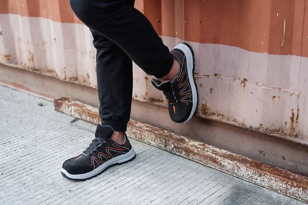 Stock image Photo of a man doing his morning run and wearing sports shoes and sweatpants