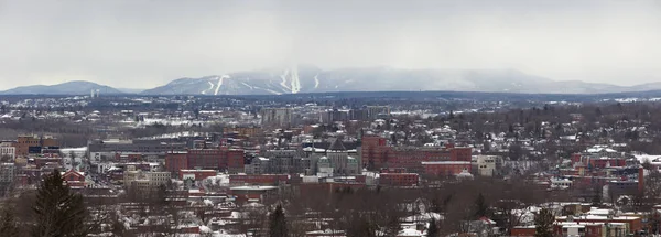 Sherbrooke downtown during winter. Panoramic view of small city in Quebec, Canada. Panoramic view snow and mountain cityscape.