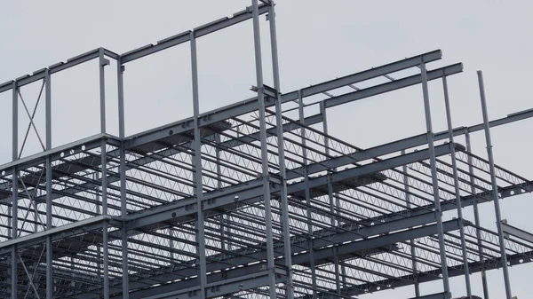construction site metal frame building corner iron beams roof structure panning