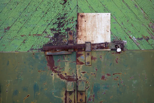 High-security barbed prison door padlock barricaded old metal rusty lock
