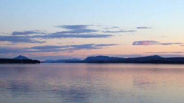 sunset lake and mountains Memphremagog landscape water sunrise in Magog, Quebec peaceful destination in Canada clipart