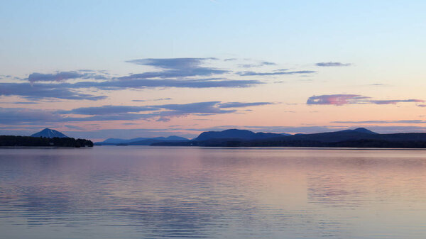 sunset lake and mountains Memphremagog landscape water sunrise in Magog, Quebec peaceful destination in Canada