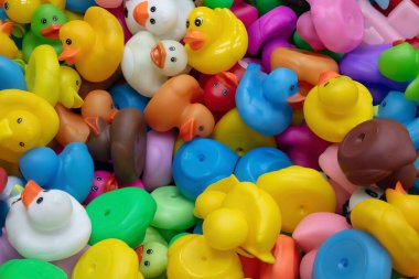 A vibrant collection of multicolored rubber duck toys filling the frame. Fun, playful, and perfect for childhood, bath, or kids themes. clipart