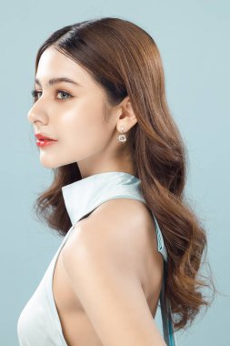 Mavi arka planda taze cildi temiz genç bir kadın modeli, kadın portresi yüz bakımı, estetik ameliyat, kozmetoloji, güzellik ve kaplıca..