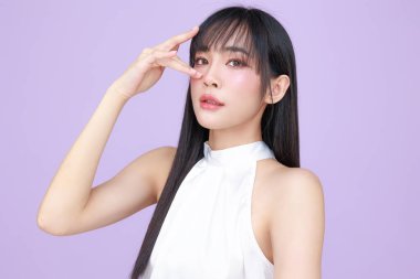 Güzel, genç, Asyalı bir kadın, uzun saçlı, doğal makyajlı, temiz tenli, izole bir menekşe. Tatlı kız portresi, yüz bakımı, vücut bakımı, güzellik ve güzellik merkezi..