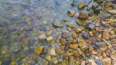 Okyanus kıyısındaki kayalara vuran dalgaların görüntüsü.