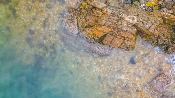 stock image the shot of waves hitting rocks on ocean coast