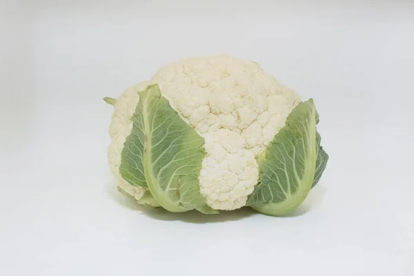 a Whole Cauliflower Vegetable with Green Leaves isolated