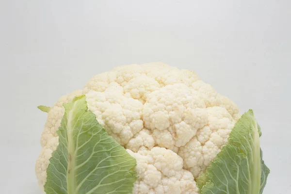 Close up Cauliflower Vegetable with Green Leaves isolated