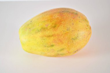 a whole and half of ripe papaya fruit with seeds isolated