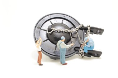 a mini figure of worker repairing toilet,