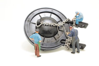 a mini figure of worker repairing toilet,