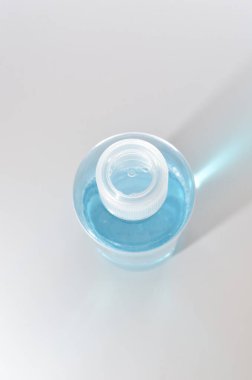 Blue alcohol sanitized bottle on white background.