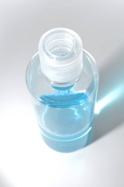 Blue alcohol sanitized bottle on white background.