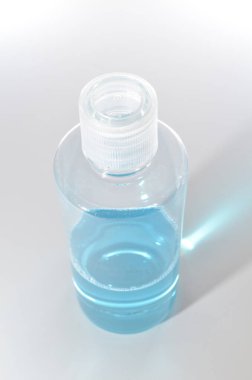 Blue alcohol sanitized bottle on white background.