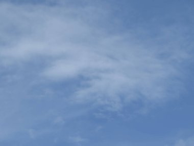a blue sky with white cloud background