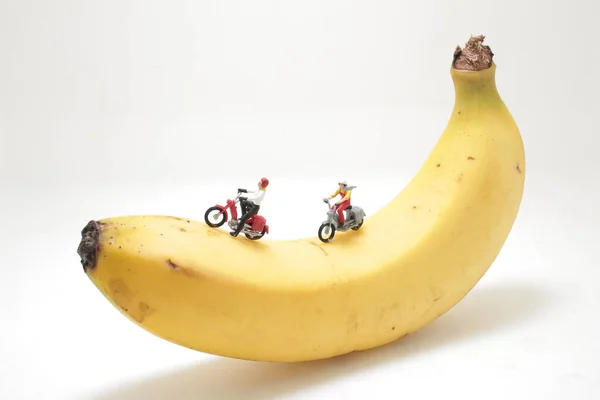 a mini figure of ride a motorbike on banana