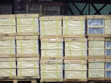 Cardboard Boxes Wrapped Plastic on Pallet Rack.