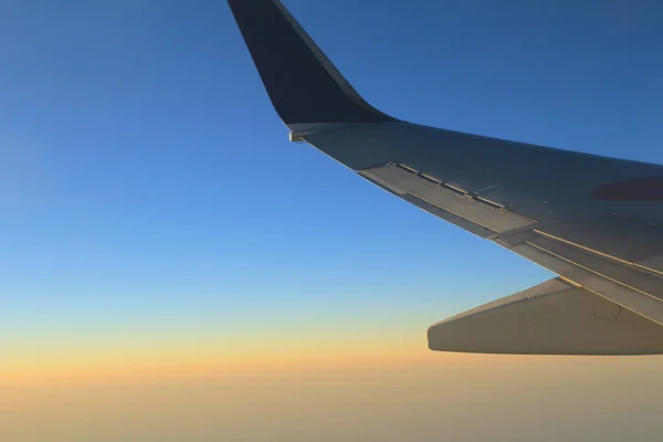 the sky from the plane, plane wing, sunset time