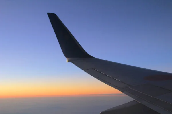 the sky from the plane, plane wing, sunset time