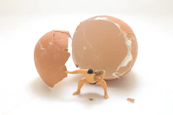 stock image a figure sumo with the egg shell