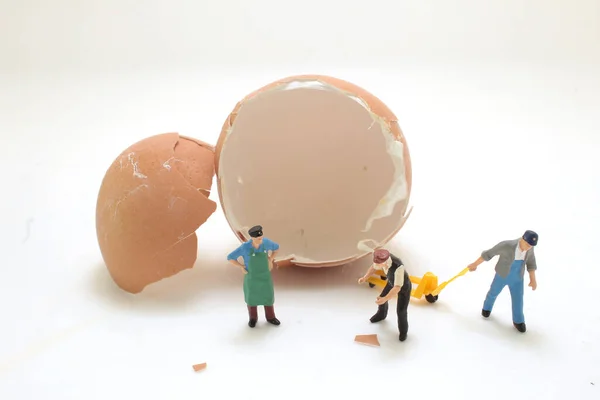 a figure worker moving the broke egg