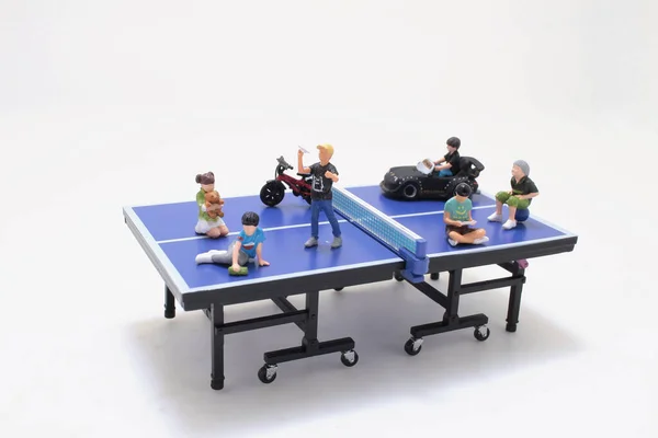 Little kids play on the table tennis
