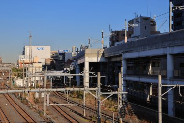 Nov 29 2023 Urban train tracks and cityscape with clear sky.